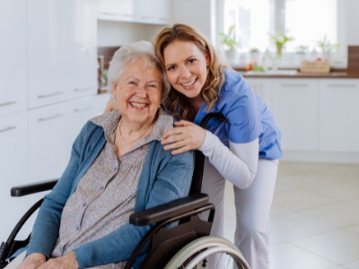 Happy woman in a wheelchair with her daughter in the accessible house after remodeling.